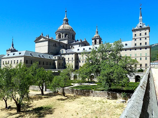 The east side of El Escorial, with the dome of the basilica rising over the gardens