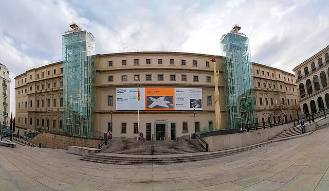 The old hospital building of the Reina Sofía Museum with its two glass towers, seen from the square