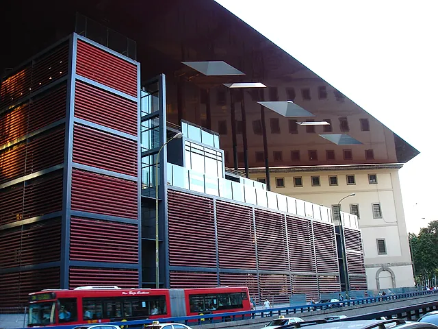 A side of the Nouvel building of the Reina Sofía Museum, with red louvres and glass walls