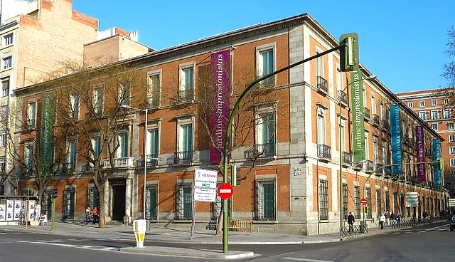 The Thyssen-Bornemisza Museum seen from the street, with banners on its façade